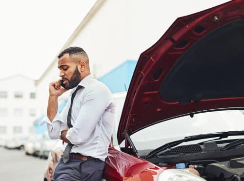 A man calling his insurance company after an accident.