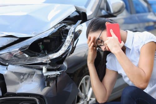 A woman calling the police after her car was damaged in a hit-and-run.