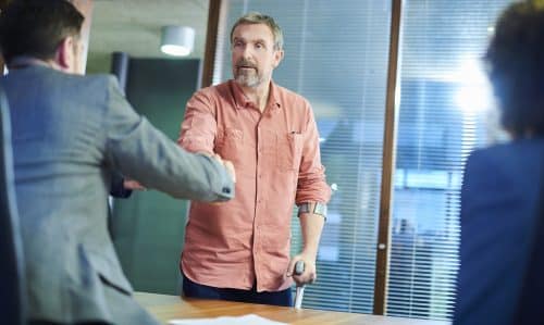 An injured man meeting with his personal injury lawyer.